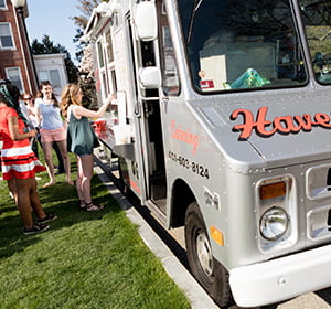 students waiting in line for haven brothers food truck
